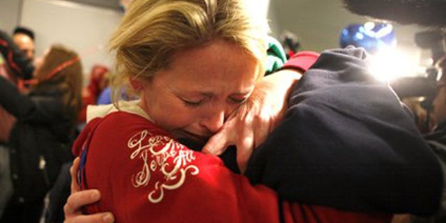 Jan. 15: Linda Callahan embraces her son as she and members of Trinity Methodist return from Haiti.