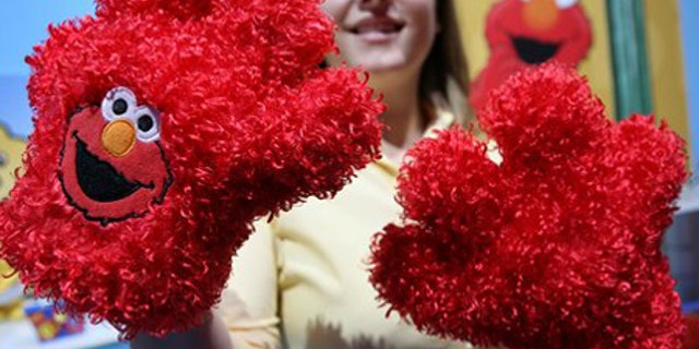 Feb. 18: Taryn Pry with Fisher Price shows off Elmo Tickle Hands, a touch activated toy featuring Sesame Street's Elmo.