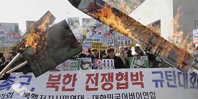 Feb. 17: South Korean protesters burn a portrait of North Korean leader Kim Jong Il and mock North Korean missile during a rally in Seoul.