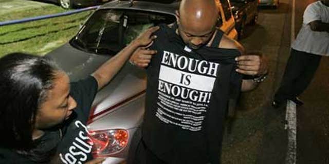 Sept. 20: Andrea Blalock, left, checks out a shirt for her husband Thomas Blalock, both from Stockbridge, Ga. as they prepare for a rally to protest the arrest of the 'Jena 6'in Louisiana. The youngest of the six was released Thursday.