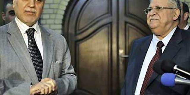 Dec. 4: Iraq's vice president Tariq al-Hashemi, left, and Iraqi President Jalal Talabani, right, hold a joint press conference in Baghdad.