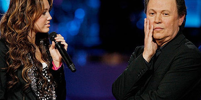 Billy Crystal is seen with Miley Cyrus on 'American Idol Gives Back.'