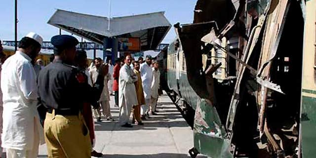 June 11: People look at a compartment of a passenger train damaged by a bomb blast in Quetta, Pakistan.