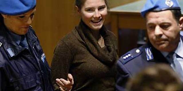 Dec. 2: Amanda Knox, convicted of murdering Meredith Kercher, is accompanied by penitentiary police officers prior to a hearing at the court in Perugia, Italy.