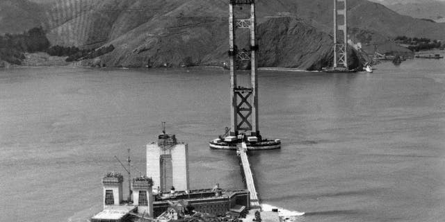 The construction of the Golden Gate Bridge, which will link Fort Point, bottom, with Marin County, Calif., top, is seen as work progressed, 1934. (AP Photo/Redwood Empire Association)