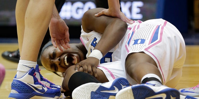 Duke's Chelsea Gray screams out as she grabs her knee following an injury during the first half of an NCAA college basketball game against Wake Forest in Durham, N.C., Sunday, Feb. 17, 2013. (AP Photo/Gerry Broome)