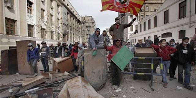 Feb. 3: Egyptian protestors block the road during clashes with security forces near the Interior Ministry in Cairo, Egypt. A volunteer doctor says police and protesters angry over a deadly soccer riot have clashed for the second day in the Egyptian capital.
