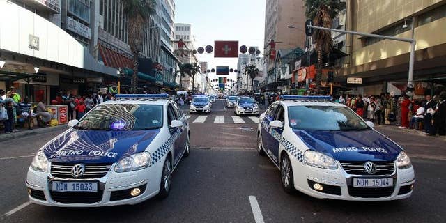 Members of the Metro Police drive their cars in Durban on July 8, 2010