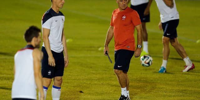 France's head coach Didier Deschamps walks on the field during an official training session at the Joao Havelange Olympic stadium, in Rio de Janeiro, Brazil, Tuesday, June 24, 2014. France will play its next game against Ecuador in group E of the 2014 soccer World Cup. A draw is enough to guarantee top spot for France, and would also send Ecuador through to the next round if Switzerland fails to beat Honduras in the other match. (AP Photo/David Vincent)
