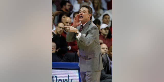 Louisville coach Rick Pitino yells instructions to the team during the first half of an NCAA college basketball game against SMU on Wednesday, March 5, 2014, in Dallas. Pitino has ashes on his forehead for Ash Wednesday. (AP Photo/John F. Rhodes)