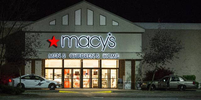 Law enforcement investigate a deadly shooting in the Macy's store at the Cascade Mall in Burlington, Wash., Friday, Sept. 23, 2016. A gunman opened fire in the crowded mall north of Seattle, killing several people and critically wounding another before fleeing Friday night, authorities said. Washington State Patrol spokesman Sgt. Mark Francis said police were searching for a Hispanic man wearing black and armed with a rifle who was last seen walking toward Interstate 5. (AP Photo/Stephen Brashear)