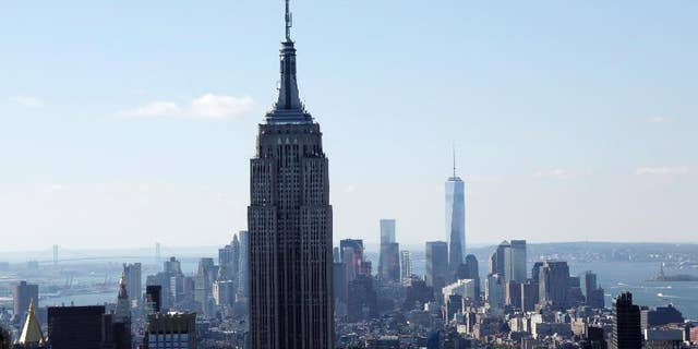 FILE - The Empire State Building and the Manhattan skyline are seen from the Rainbow Room, New York City’s landmark restaurant atop 30 Rockefeller Plaza, in this Sunday, Oct. 5, 2014 file photo. Hundreds of people will take to the stairs at the Empire State Building on Wednesday night Feb. 4, 2015, climbing from the lobby to the 86th floor observatory. They'll be going up the 1,576 steps as part of the 38th annual Empire State Building Run-Up. (AP Photo/Mark Lennihan, File)