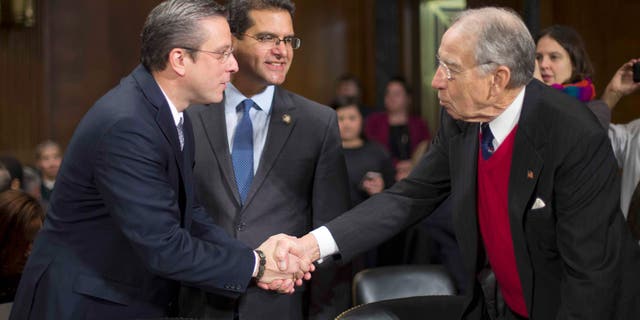 Sen. Chuck Grassley greets Puerto Rico Gov. Alejandro Garcia Padilla on Capitol Hill, Tuesday, Dec. 1, 2015.