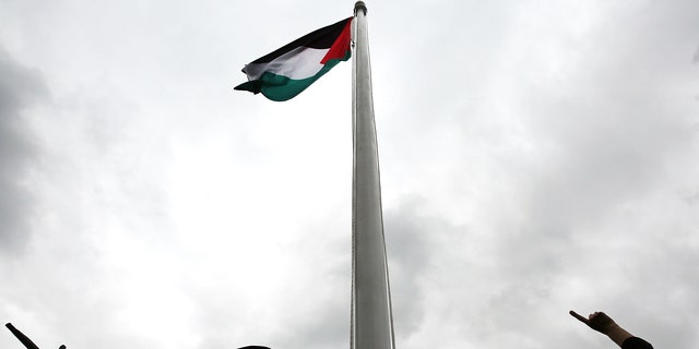 NEW YORK, NY - SEPTEMBER 30: The Palestinian flag is raised for the first time at the United Nations headquarters on September 30, 2015 in New York City. Following remarks by Palestinian President Mahmoud Abbas, the flag was raised in the rose garden at 1:00pm local time in front of a large crowd of diplomats, reporters and Palestinian supporters. (Photo by Spencer Platt/Getty Images)