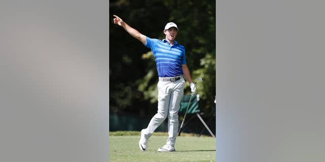 Rory McIlroy warns spectators of his errant shot on the second tee during the second round of play at the Tour Championship golf tournament at East Lake Golf Club Friday, Sept. 23, 2016, in Atlanta. (AP Photo/John Bazemore)