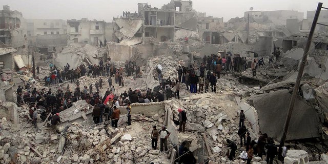 This citizen journalism image provided by Aleppo Media Center AMC, which has been authenticated based on its contents and other AP reporting, shows people searching through the debris of destroyed buildings in the aftermath of a strike by Syrian government forces, in the neighborhood of Jabal Bedro, Aleppo, Syria, Tuesday Feb. 19, 2013. The U.N. Commission of Inquiry on Syria released a 131-page report Monday, Feb. 18, 2013, detailing deepening radicalization by both sides and says fighters on both sides in Syria's civil war have committed atrocities and should be brought to justice. (AP Photo/Aleppo Media Center AMC)