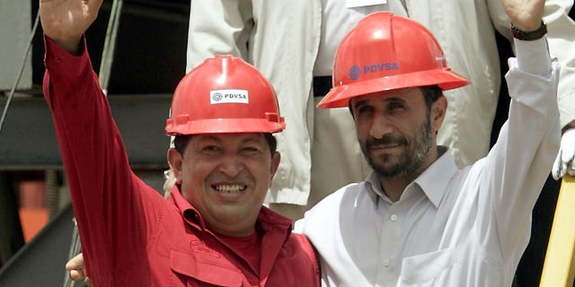 FILE - In this Sept. 18, 2006 file photo, Venezuela's President Hugo Chavez, left, and Iran's President Mahmoud Ahmadinejad wave to the press after inaugurating an oil drill in San Tome, Venezuela. Venezuela's Vice President Nicolas Maduro announced on Tuesday, March 5, 2013 that Chavez has died. Chavez, 58, was first diagnosed with cancer in June 2011. (AP Photo/Fernando Llano, File)