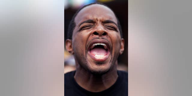 Jay Morrison gives a speech in front of the Triple S convenience store in Baton Rouge, Saturday, July 9, 2016. Protest were planned all over Baton Rouge by groups demanding justice for Alton Sterling, a black man killed by white police officers on Tuesday. (AP Photo/Max Becherer)