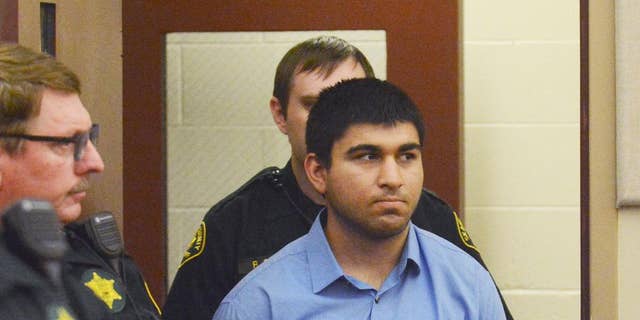 Arcan Cetin is escorted into Skagit County District Court by Skagit County's Sheriff's Deputies on Monday, Sept. 26, 2016. Cetin is being held under a magistrate's warrant which will give Skagit County prosecutors 30 days to file charges in relation to the Cascade Mall shooting that took place on Friday evening. Five people were killed in the shooting, and Cetin is being held on a $2 million bail. (Brandy Shreve/Skagit Valley Herald via AP)