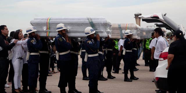 Coffins carrying LaMia flight crew members who died in a plane crash are carried by soldiers to a hearse at the Viru Viru airport in Santa Cruz, Bolivia, Friday, Dec. 2, 2016. Victims of this week's tragic air crash in the Andes were flown home Friday as Bolivia's president called for "drastic measures" against aviation officials who signed off on a flight plan that experts and even one of the charter airline's executives said should never have been attempted because of a possible fuel shortage. (AP Photo/Juan Karita)