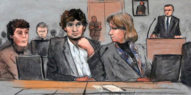 In this courtroom sketch, Assistant U.S. Attorney Aloke Chakravarty is depicted pointing to defendant Dzhokhar Tsarnaev, right, during closing arguments in Tsarnaev's federal death penalty trial Monday, April 6, 2015, in Boston. 