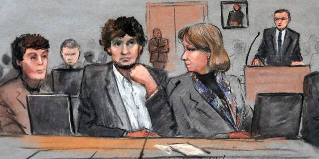 In this courtroom sketch, Assistant U.S. Attorney Aloke Chakravarty is depicted pointing to defendant Dzhokhar Tsarnaev, right, during closing arguments in Tsarnaev's federal death penalty trial Monday, April 6, 2015, in Boston.