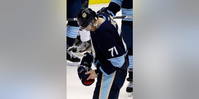 Pittsburgh Penguins center Evgeni Malkin skates to the locker room during the third period of an NHL hockey game against the Florida Panthers in Pittsburgh on Friday, Feb. 22, 2013. The Penguins won 3-1. Malkin did not return to the game. (AP Photo/Gene J. Puskar)