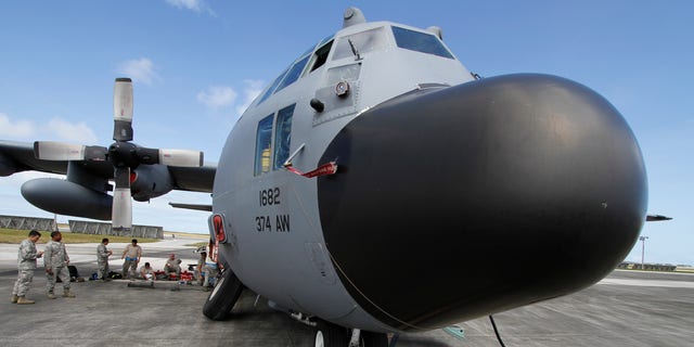 Feb. 7, 2013: Members of the 374th Airlift Wing of U.S. Air Force work on a C-130 aircraft during the Cope North military exercises at Andersen U.S. Air Force Base in Guam.