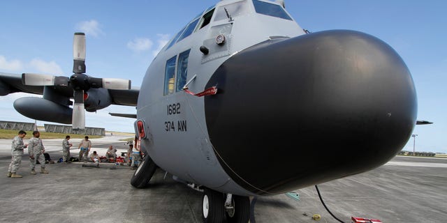 Feb. 7, 2013: Members of the 374th Airlift Wing of U.S. Air Force work on a C-130 aircraft during the Cope North military exercises at Andersen U.S. Air Force Base in Guam.