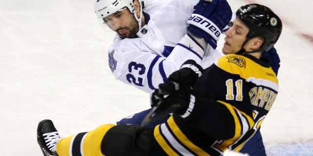 Toronto Maple Leafs defenseman Ryan O'Byrne (23) checks Boston Bruins center Gregory Campbell (11) during the first period in Game 5 of an NHL hockey Stanley Cup playoff series in Boston, Friday, May 10, 2013. (AP Photo/Charles Krupa)