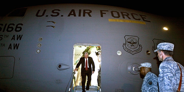 April 6: U.S. Defense Secretary Robert Gates steps off of his C-17 airplane before being met by U.S. Army Gen. Lloyd Austin, center, commanding general of U.S. Forces in Iraq, in Baghdad, Iraq.