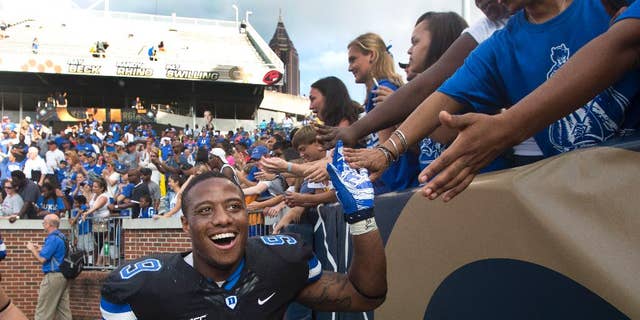 Duke running back Josh Snead (9) celebrates with fans after defeating Georgia Tech 31-25 in an NCAA college football game Saturday, Oct. 11, 2014, in Atlanta. (AP Photo/John Bazemore)