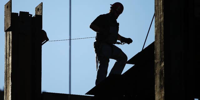 FILE - In this Sept. 15, 2015, file photo, an iron worker works on the new Comcast Innovation and Technology Center under construction, in Philadelphia. The Commerce Department reports on U.S. construction spending in November, on Monday, Jan. 4, 2016. (AP Photo/Matt Rourke, File)