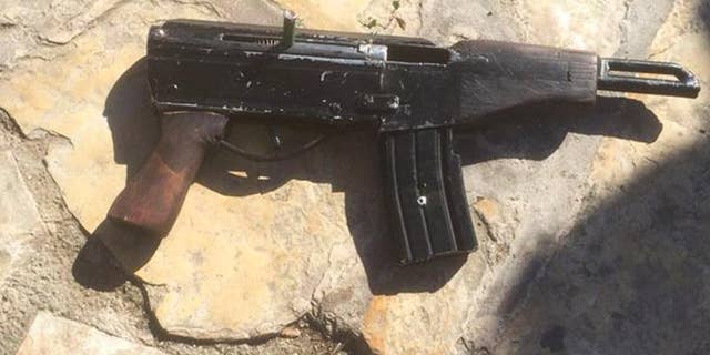 This undated photo provided by the Israeli Police shows a handmade gun produced in the West Bank. Welded together from spare gun parts and pipes, the gun looks like a handgun but with an extended barrel and a long magazine of bullets. The weapon, known by its street name "Carlo," was used by Palestinian gunmen to kill four people and wound five others in Tel Aviv on Wednesday night as well as several other attacks since the current round of violence erupted in September. (Israeli Police via AP)