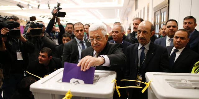 Palestinian president Mahmud Abbas casts his vote at the Muqataa, the Palestinian Authority headquarters, in the city of Ramallah, West Bank, Saturday Dec. 3, 2016. (Ahmad Gharabli/Pool photo via AP)