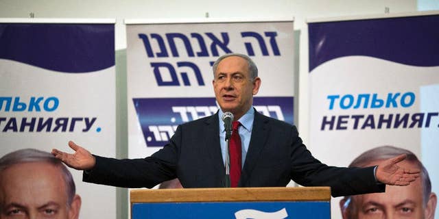 Israeli Prime Minister Benjamin Netanyahu speaks to his Likud party members during a campaign event near Tel Aviv, Israel, Monday, Feb. 9, 2015. Netanyahu on Monday accused the publisher of the Yediot Ahronot daily newspaper of carrying out a smear campaign against him in the hopes of pushing him out of office.  (AP Photo/Ariel Schalit)