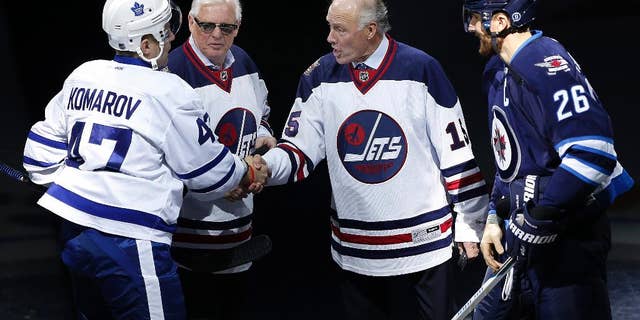 Former Winnipeg Jets' Anders Hedberg, second from right, shakes hands with Toronto Maple Leafs' Leo Komarov (47) as Ulf Nilsson and Winnipeg Jets' Blake Wheeler (26) watch during the induction ceremony for the Winnipeg Jets Hall of Fame in Winnipeg, Manitoba, on Wednesday, Oct. 19, 2016. Bobby Hull was also inducted but did not attend. (John Woods/The Canadian Press via AP)
