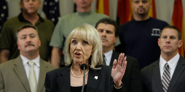 FILE: In this Apr. 23, 2010, photo, Arizona Gov. Jan Brewer talks about signing the immigration bill that is now the subject of a potential Supreme Court appeal.