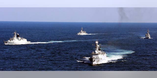 FILE - In this Oct. 19, 2012 file photo, Chinese navy vessels take part in a drill in the waters off Zhoushan in east China's Zhejiang province. Despite pressure from Washington and elsewhere, China appears determined to avoid granting any hint of legitimacy to the U.N. abitration tribunal that might challenge its claim to ownership of virtually the entire South China Sea, including its islands, reefs, fish stocks and potentially rich reserves of oil and gas. (AP Photo/File) CHINA OUT