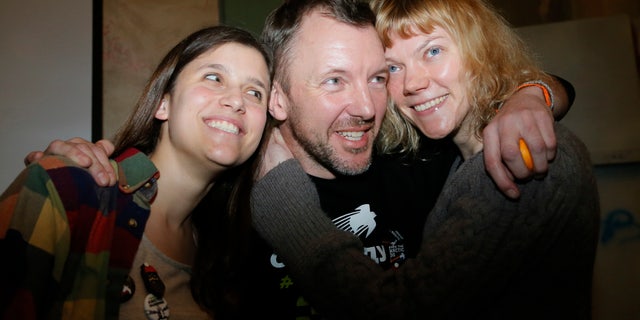 From left: Greenpeace International activists Camila Speziale of Argentina, Phiip Ball of the United Kingdom and Sini Saarela of Finland pose during their meeting with residents of St.Petersburg, Russia, Monday, Dec. 23, 2013. Russia's parliament last Wednesday passed an amnesty bill that will likely apply to the 30-member crew of a Greenpeace ship detained after an Arctic protest, but it wasn't immediately clear if and when the activists would be allowed to leave the country. (AP Photo/Dmitry Lovetsky)
