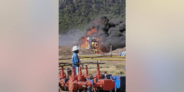 FILE - In this 2010 file photo, an oil well undergoes testing in the Lake Albertine region of western Uganda. Uganda's hopes to produce crude oil by 2018 have been boosted by an agreement to build a pipeline to Tanzania's Tanga port, a government official said Tuesday, April 26, 2016. (AP Photo/Monitor Publications Ltd, File)