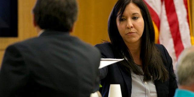 Dr. Janeen DeMarte an expert witness for the prosecution takes evidence from Prosecutor Juan Martinez during the Jodi Arias trial at Maricopa County Superior Court in Phoenix on Tuesday, April 16, 2013. Defense attorneys rested their case Tuesday after about 2 1/2 months of testimony aimed at portraying Arias as a domestic violence victim who fought for her life the day she killed her one-time boyfriend. (AP Photo/The Arizona Republic, David Wallace, Pool)