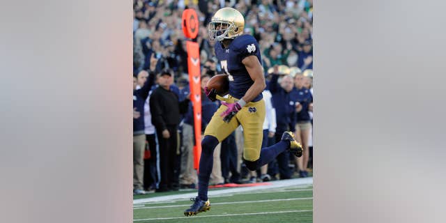 Notre Dame wide receiver Will Fuller heads towards the endzone for a touchdown in the second half of an NCAA college football game against North Carolina, Saturday, Oct. 11, 2014, in South Bend, Ind. (AP Photo/Joe Raymond)