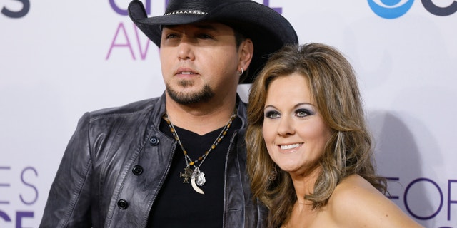 Country music star Jason Aldean and his wife Jessica arrive at the 2013 People's Choice Awards in Los Angeles, January 9, 2013.