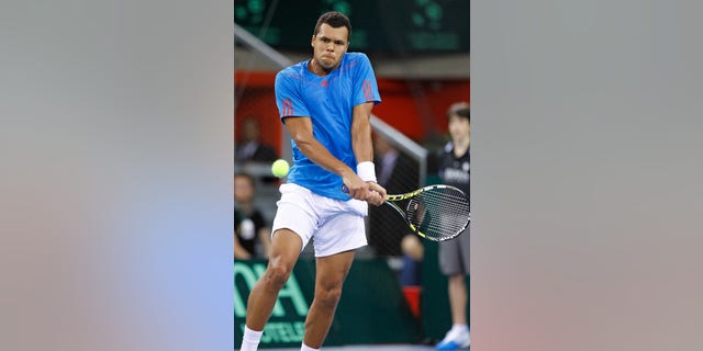 French player Jo Wilfried Tsonga returns the ball to Amir Weintraub of Israel during their match, in the first round of the Davis Cup between Israeli and France, in Rouen, western France, Friday Feb.1, 2013. (AP Photo/Remy de la Mauviniere)