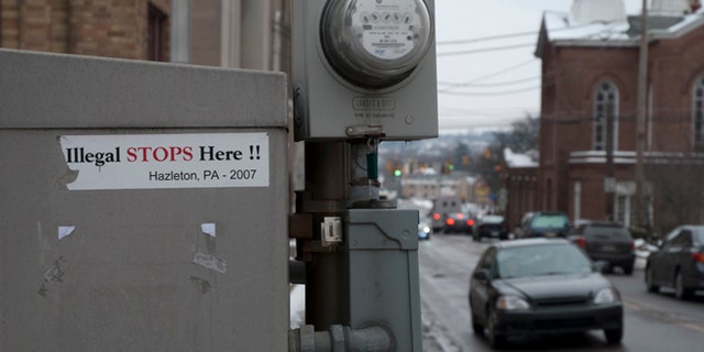 Stickers of the 2006 immigration battle in Hazleton still remain near the town's city hall. (Photo: Andrew O'Reilly)