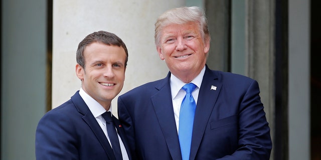 French President Emmanuel Macron greets U.S. President Donald Trump at the Elysee Palace in Paris, France, July 13, 2017. Trump has returned to Paris for ceremonies commemorating the end of World War I.