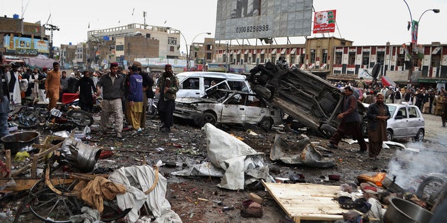 Jan. 10, 2013 - Pakistani police officers and local residents gather at the site of a bomb blast that targeted paramilitary soldiers in a commercial area in Quetta, Pakistan.