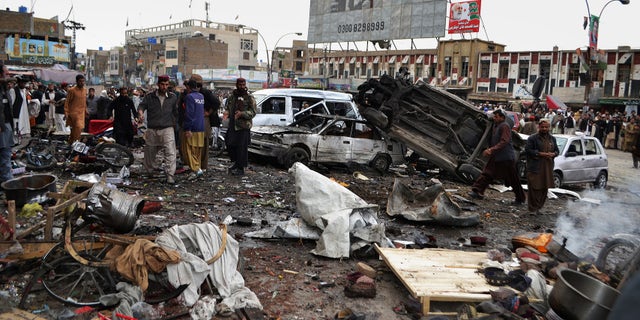 Jan. 10, 2013 - Pakistani police officers and local residents gather at the site of a bomb blast that targeted paramilitary soldiers in a commercial area in Quetta, Pakistan.