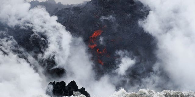 FILE: Lava flows into the ocean near Pahoa, Hawaii. Officials say an explosion sent lava flying through the roof of a tour boat.